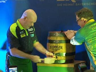 Michael van Gerwen zapft ein Holzfass Erdinger Helles an. Was ein kurioses Bild abgibt, hat einen Hintergrund: Die PDC Europe hat die Traditionsmarke als Getränkepartner gewonnen. 